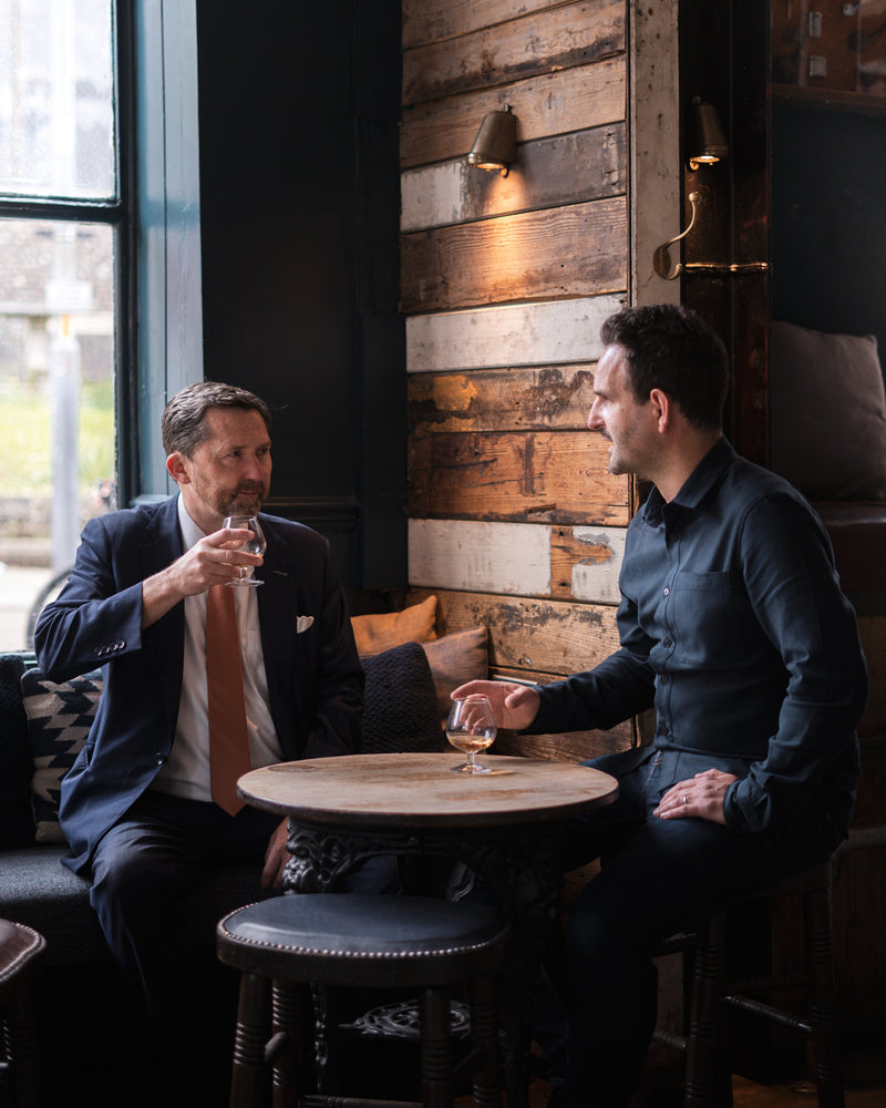 Jon (left) and Ben (right) having a conversation and drinking whisky